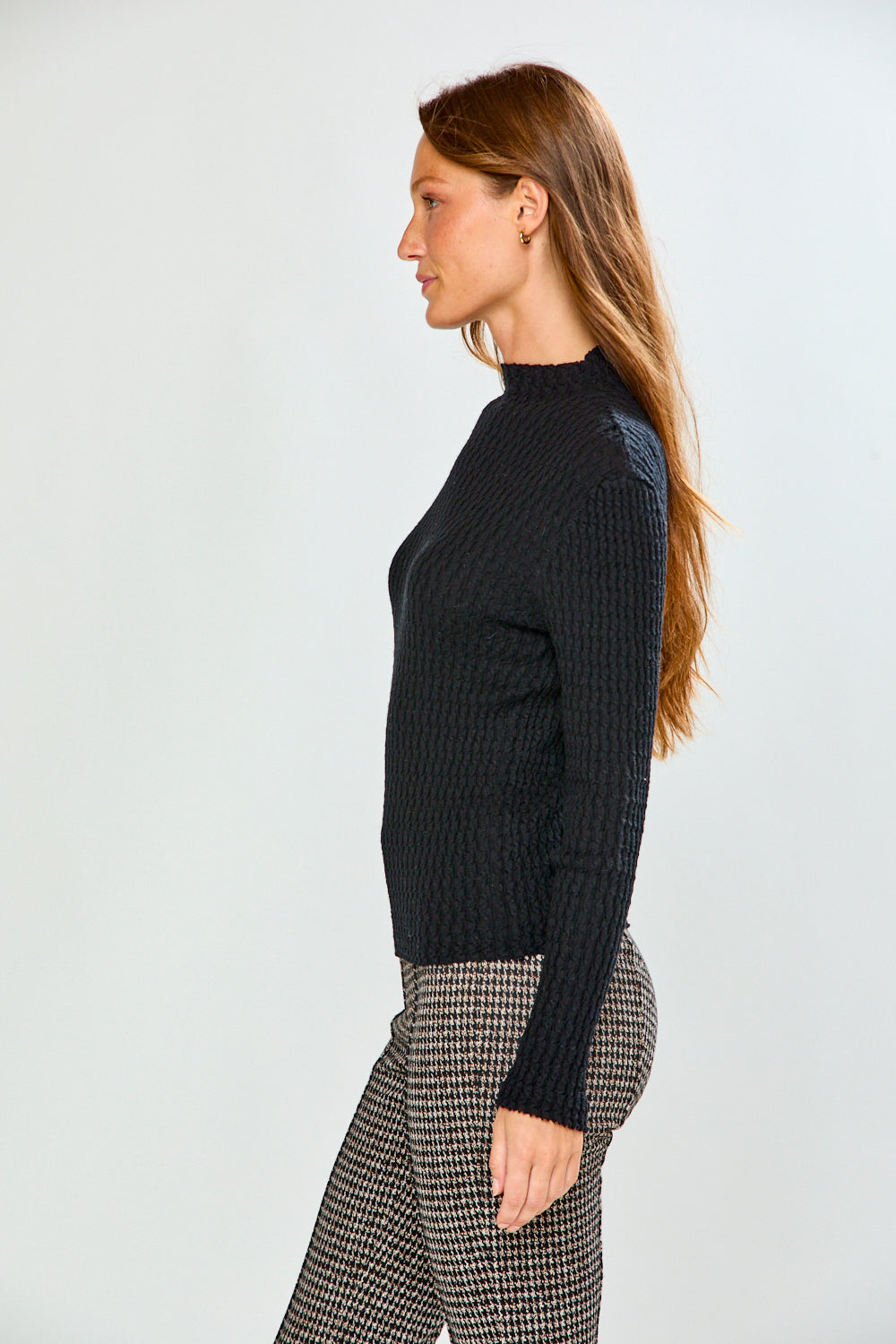 Woman in black long sleeve textured top