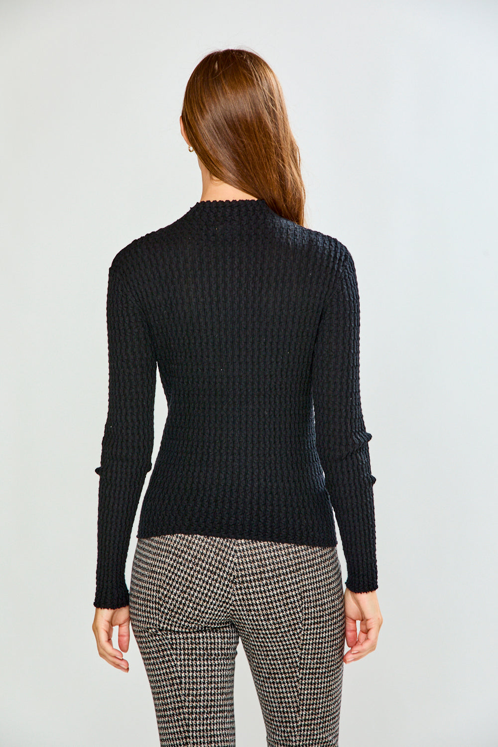 Woman in black long sleeve textured top