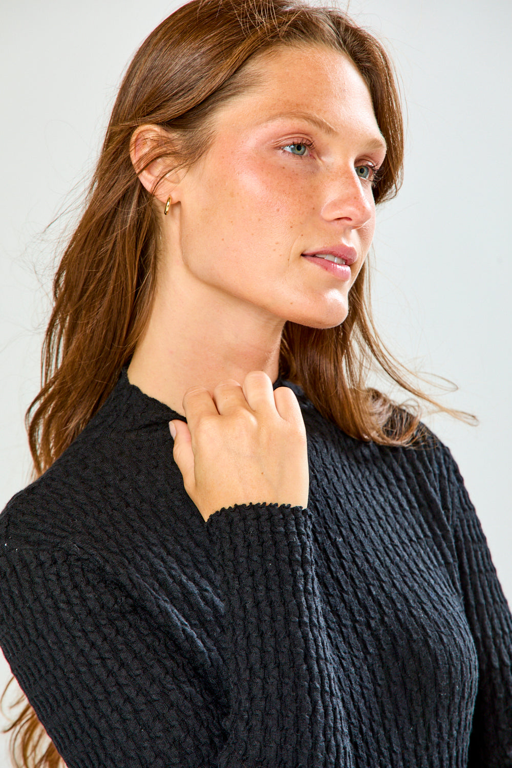 Woman in black long sleeve textured top