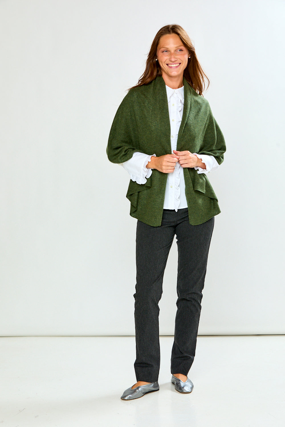 The Classic Cashmere Scarf styled with a sophisticated green wrap jacket white blouse dark pants and silver flats for a timeless look
