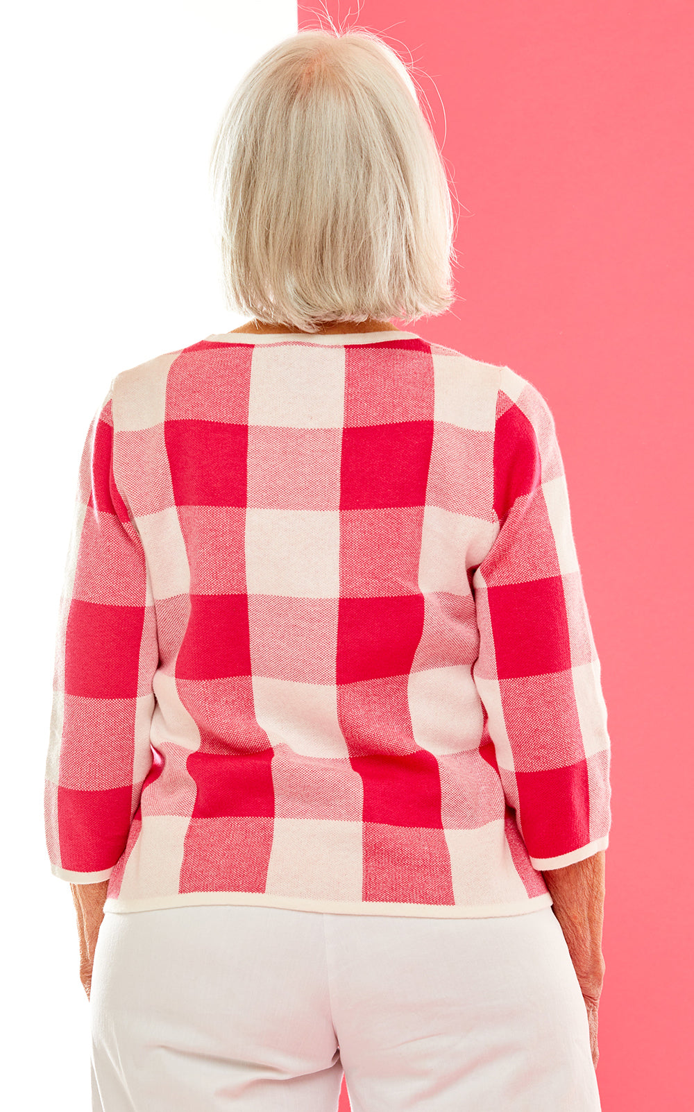 Woman in pink gingham sweater