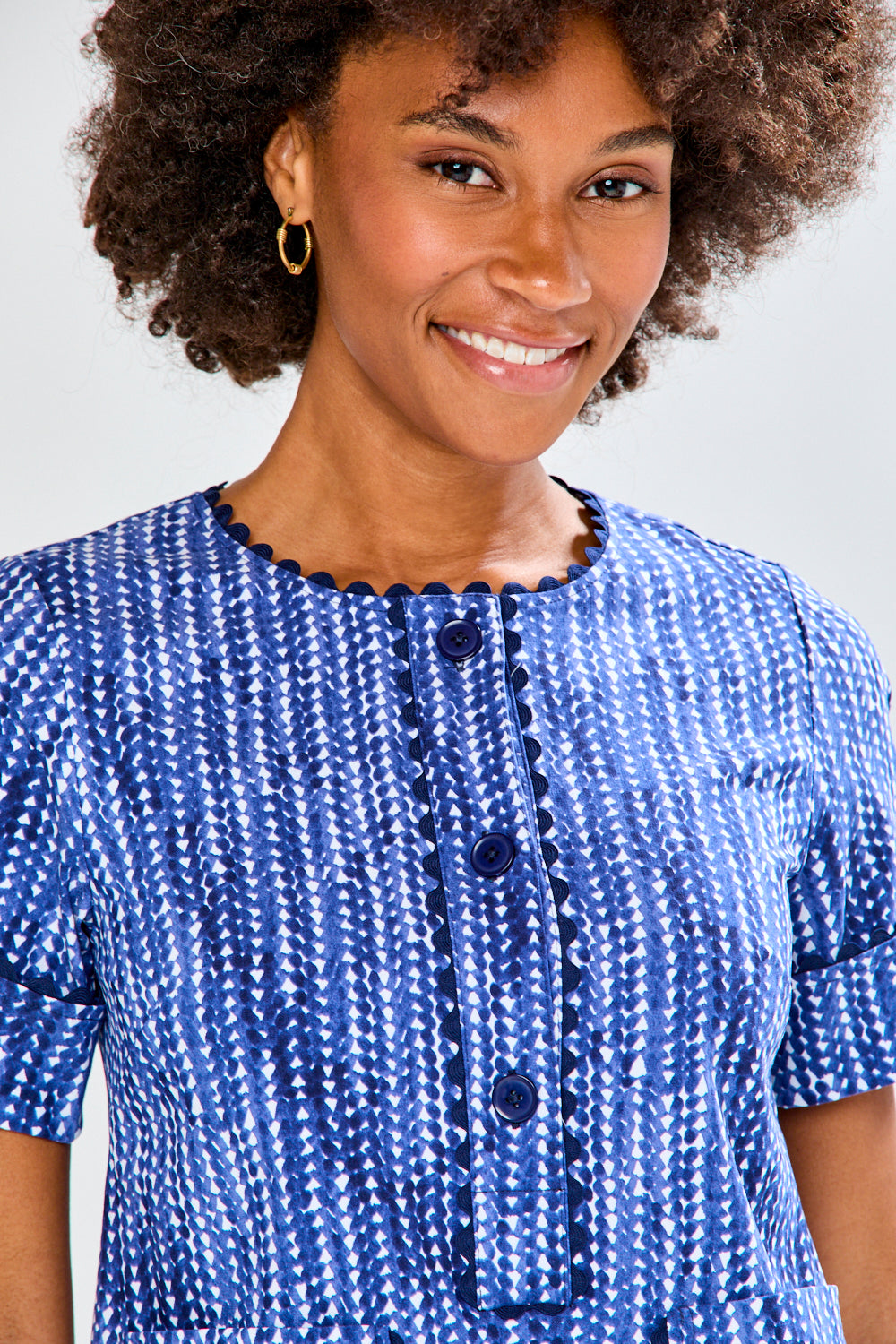 Woman wearing a blue dress with a white background