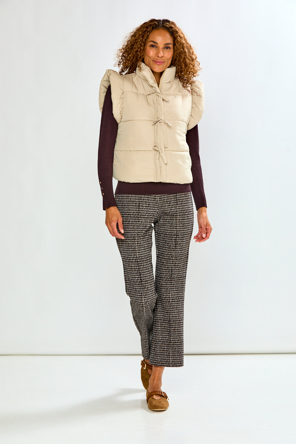 woman in tan vest