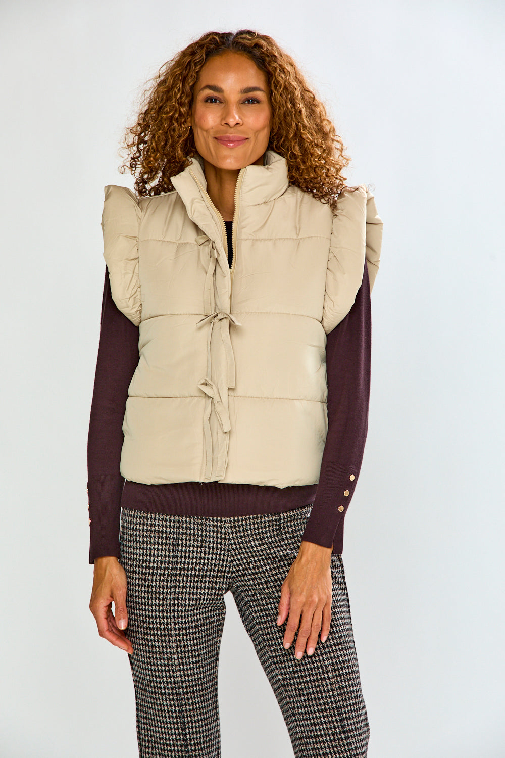 woman in tan vest