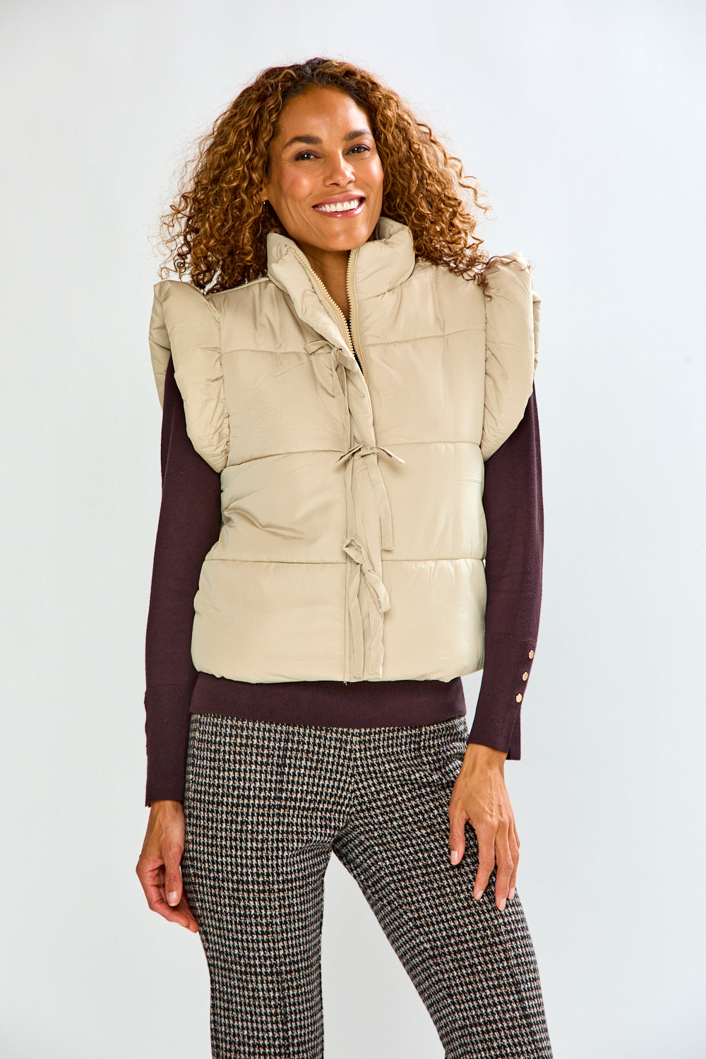 woman in tan vest