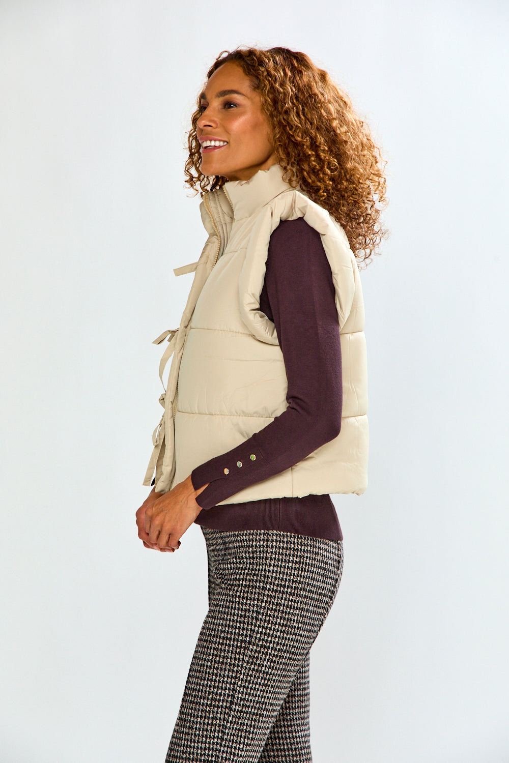 woman in tan vest