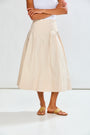 woman in pleated skirt