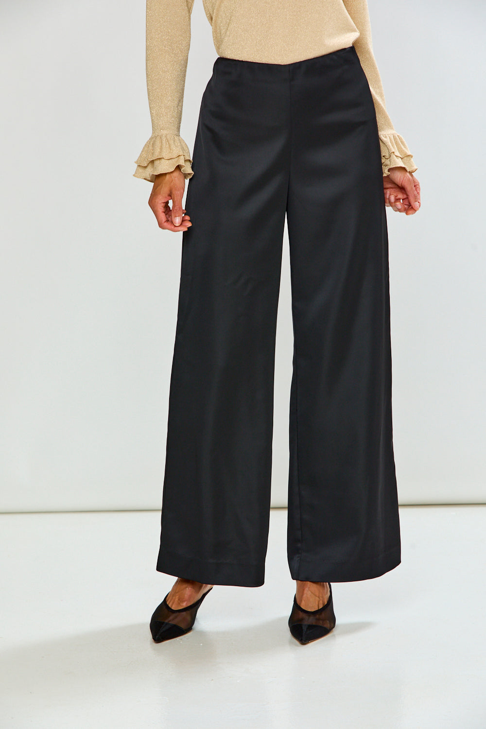 The Reyna Pant - Black, sophisticated women's pants with a high waist and wide leg silhouette styled with a ruffled sweater and pointed shoes