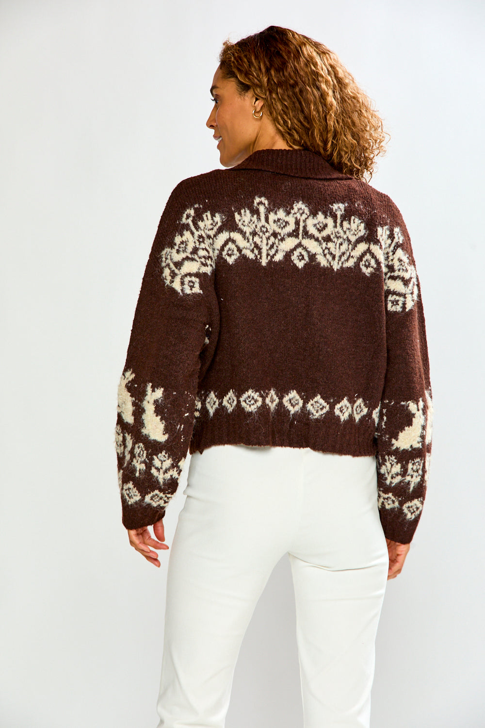 The Bunny Toggle Sweater - Brown Multi shown from the back with cream bunny and floral motifs on a brown cropped knit sweater