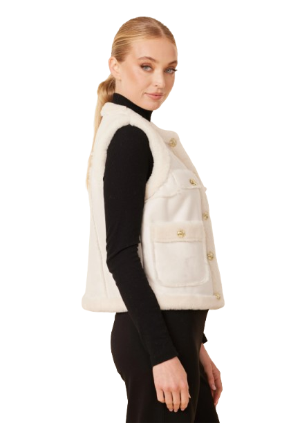 Woman wearing a white fur vest with gold buttons on a white background