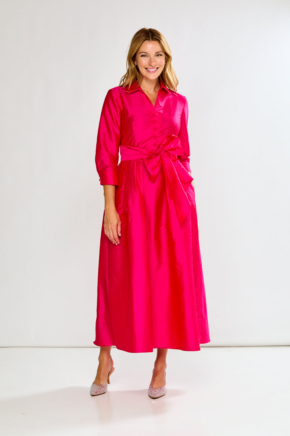 Woman wearing a Fuchsia dress on a white background