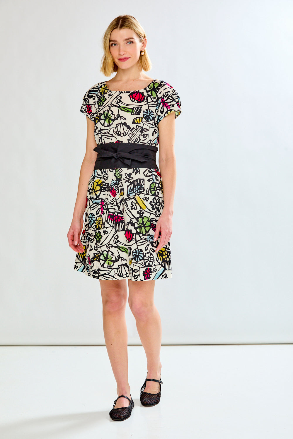Woman wearing a printed dress on a white background