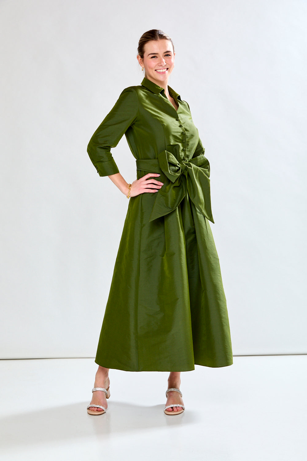 Woman in olive taffeta dress
