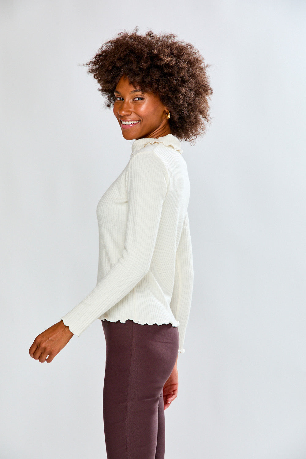 Woman in ivory top and dark pants