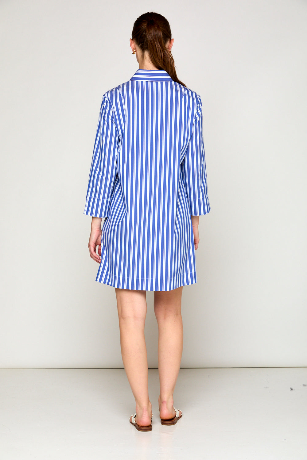 Woman in blue and white stripe dress