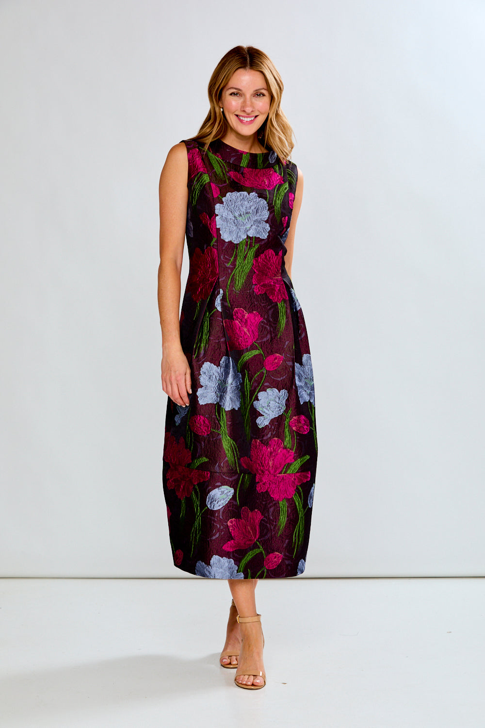 Woman wearing a floral dress on a white background