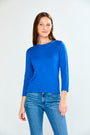 Woman wearing a blue sweater and jeans on a white background