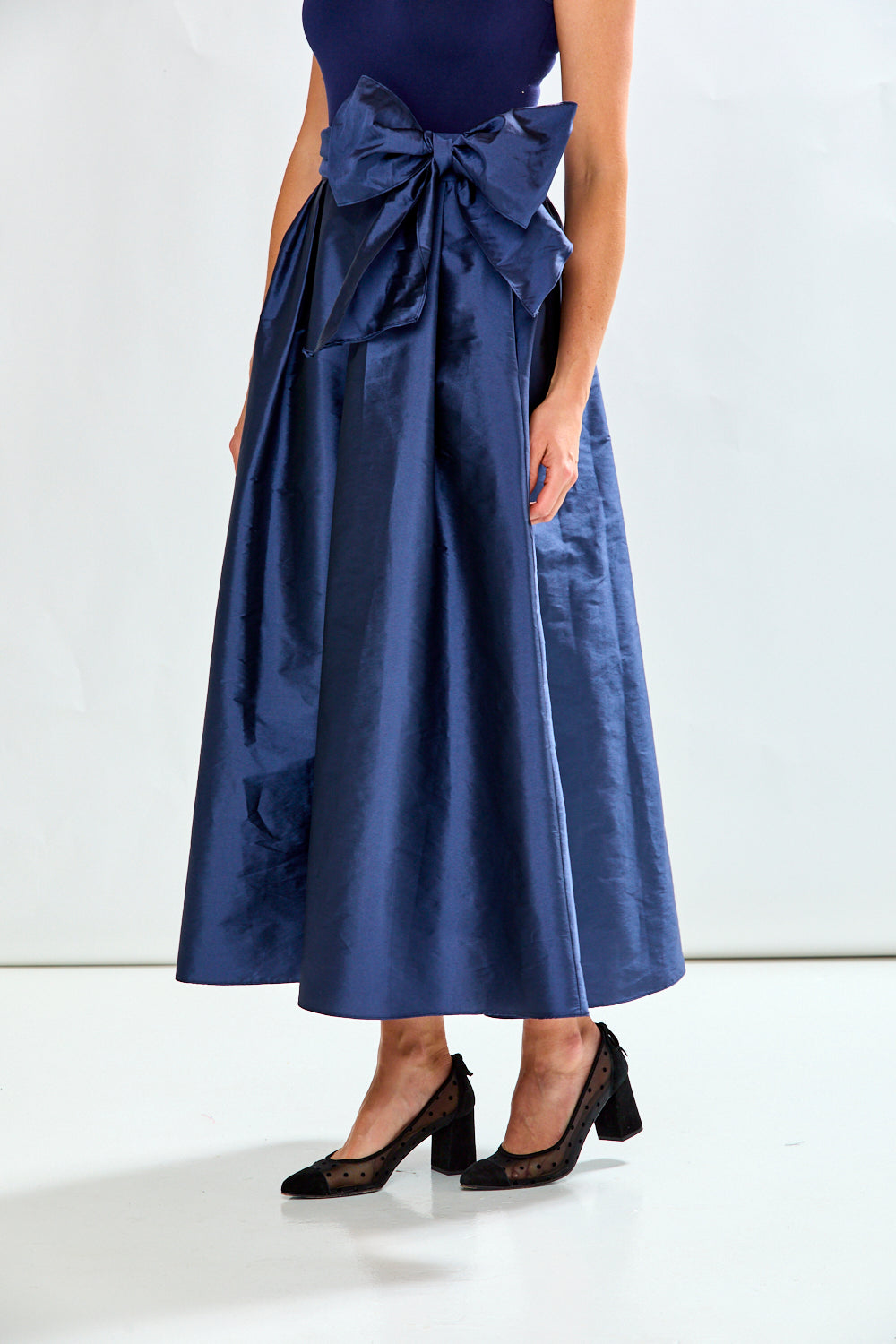 Woman wearing navy taffeta skirt