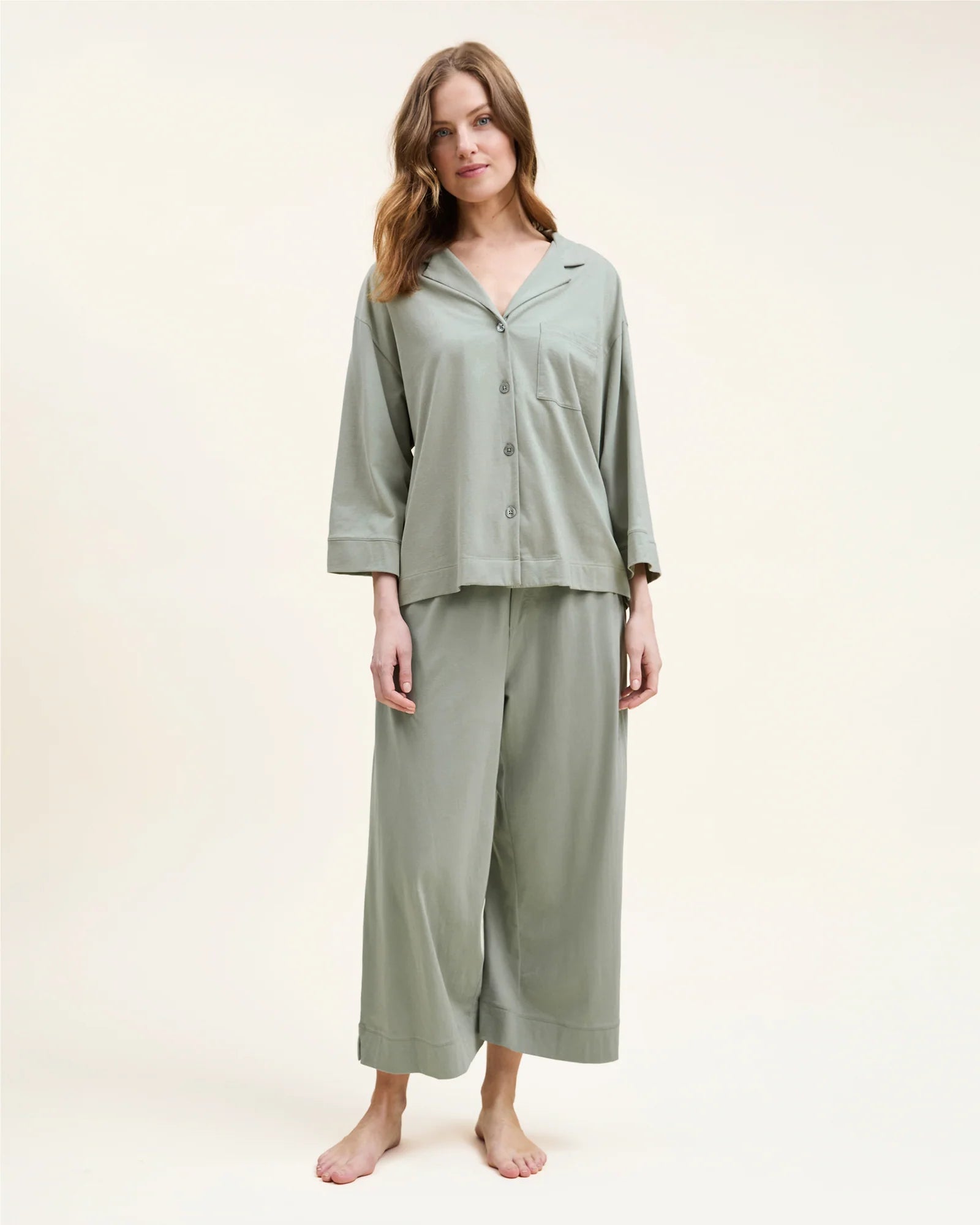 Woman in sage green pajamas
