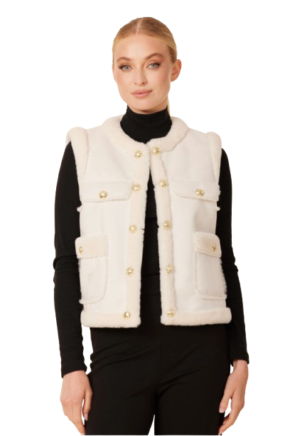 Woman wearing a white fur vest with gold buttons on a white background