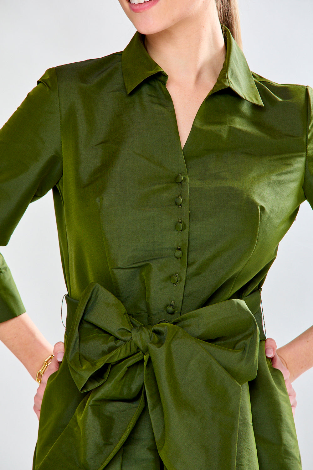 Woman in olive taffeta dress