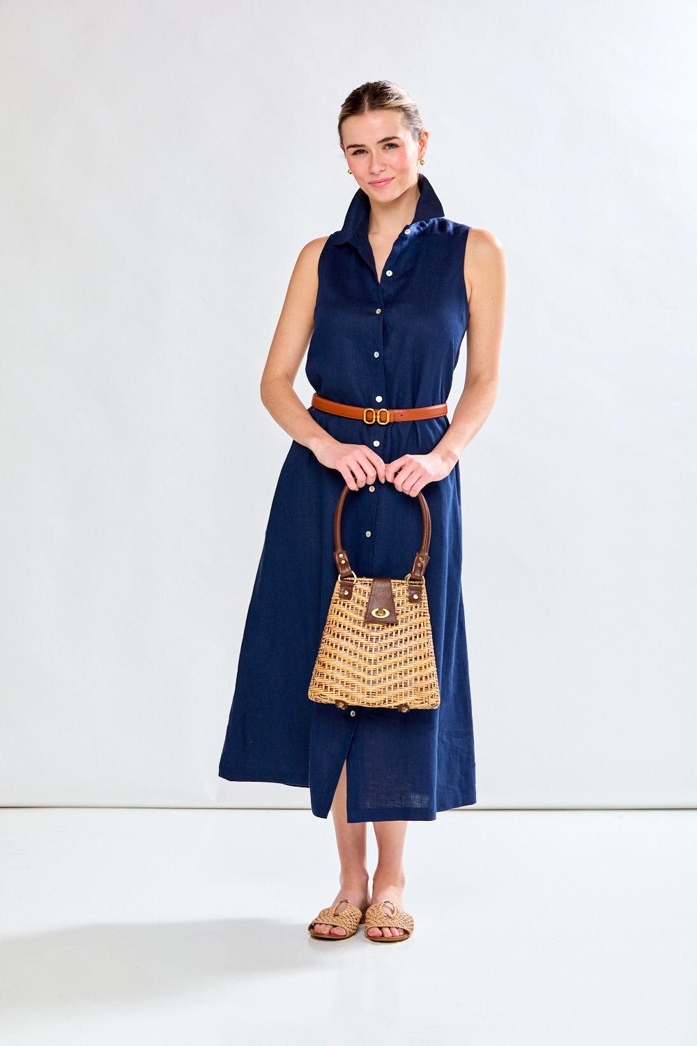 Woman in navy sleeveless dress