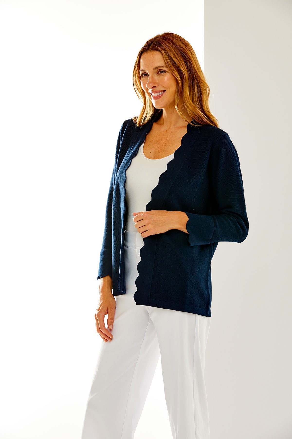 Woman in navy scallop cardigan