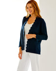 Woman in navy scallop cardigan