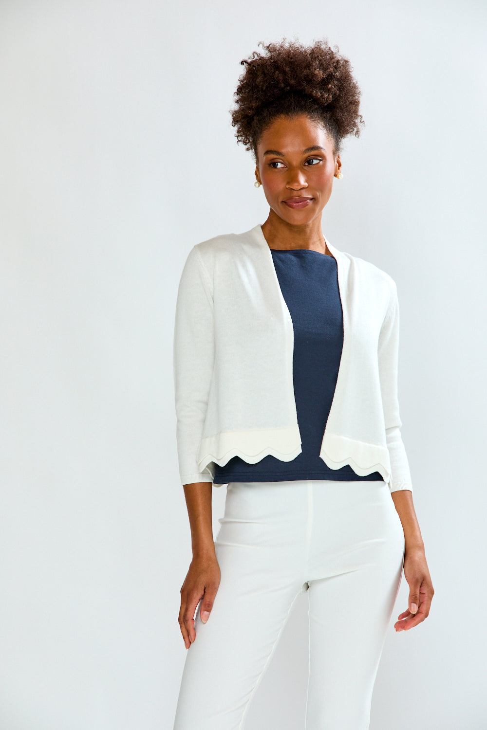 woman in white scalloped sweater