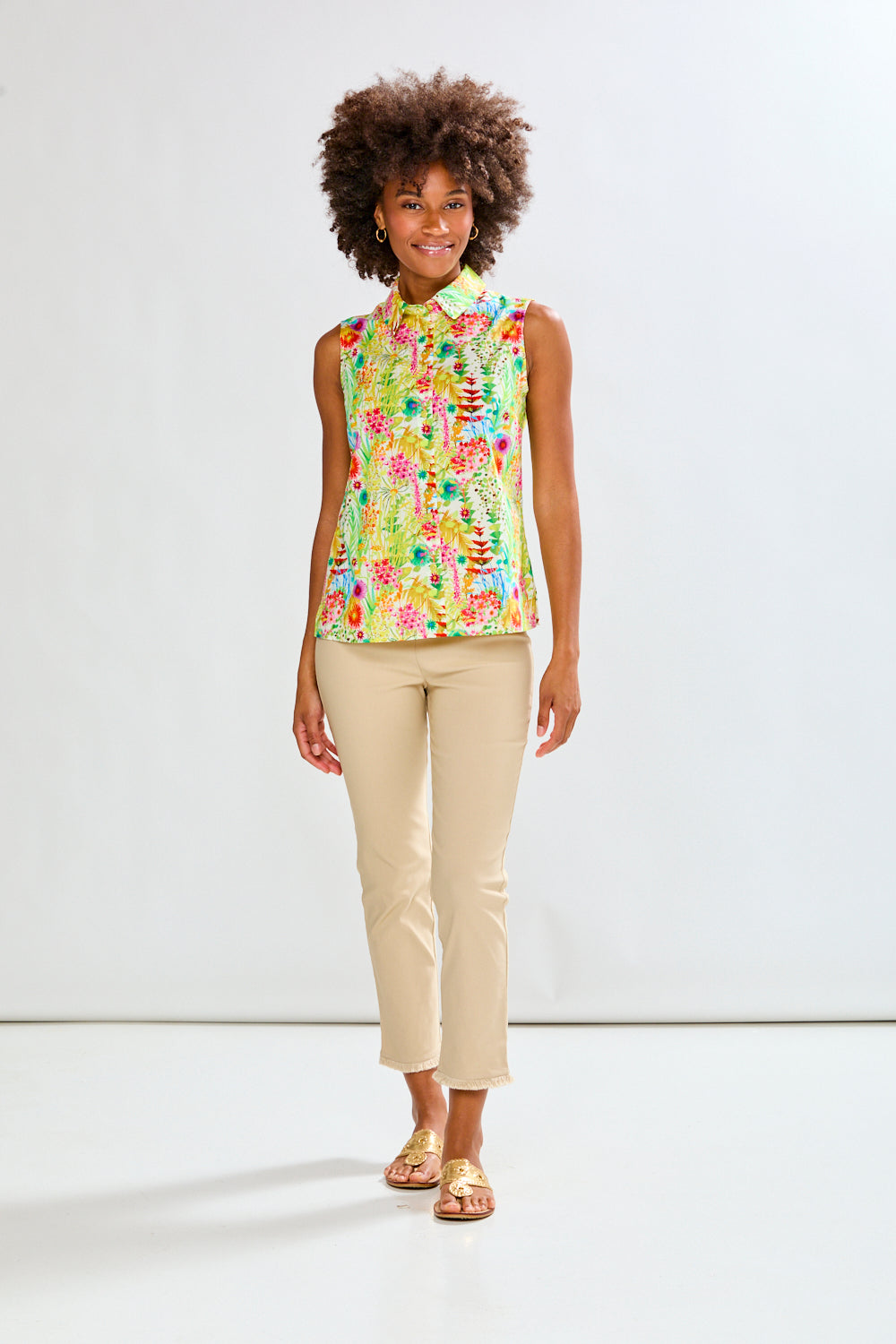 Woman in floral shirt and tan pants 