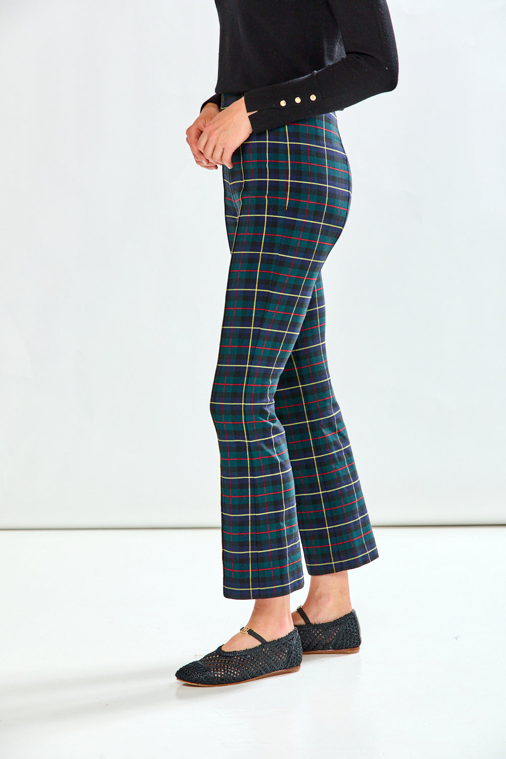 Woman wearing plaid pants on a white background