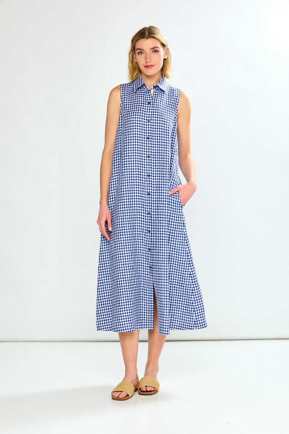 Woman wearing a blue checkered dress on a white background