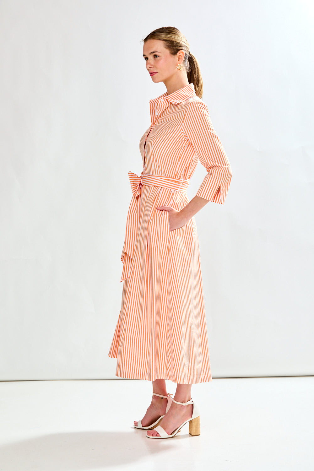 Woman in orange stripe dress
