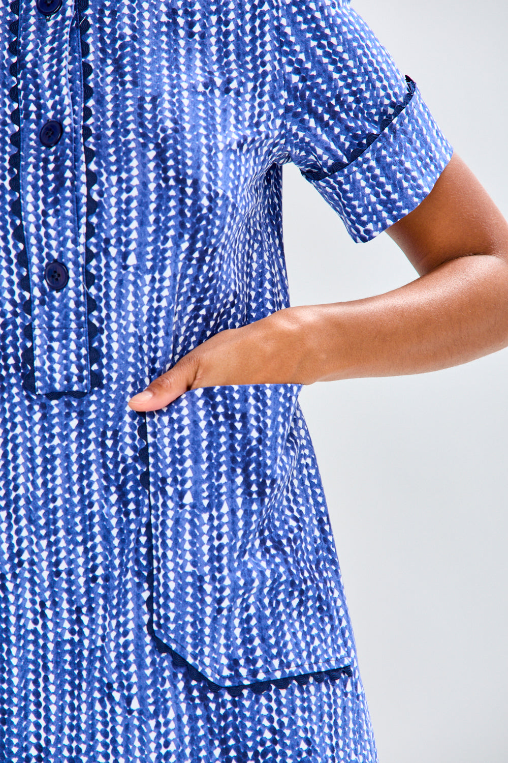 Woman wearing a blue dress with a white background