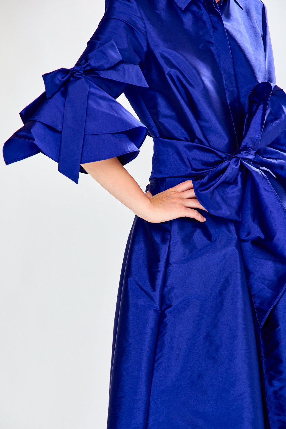 Blue dress with ruffled sleeves on a white background