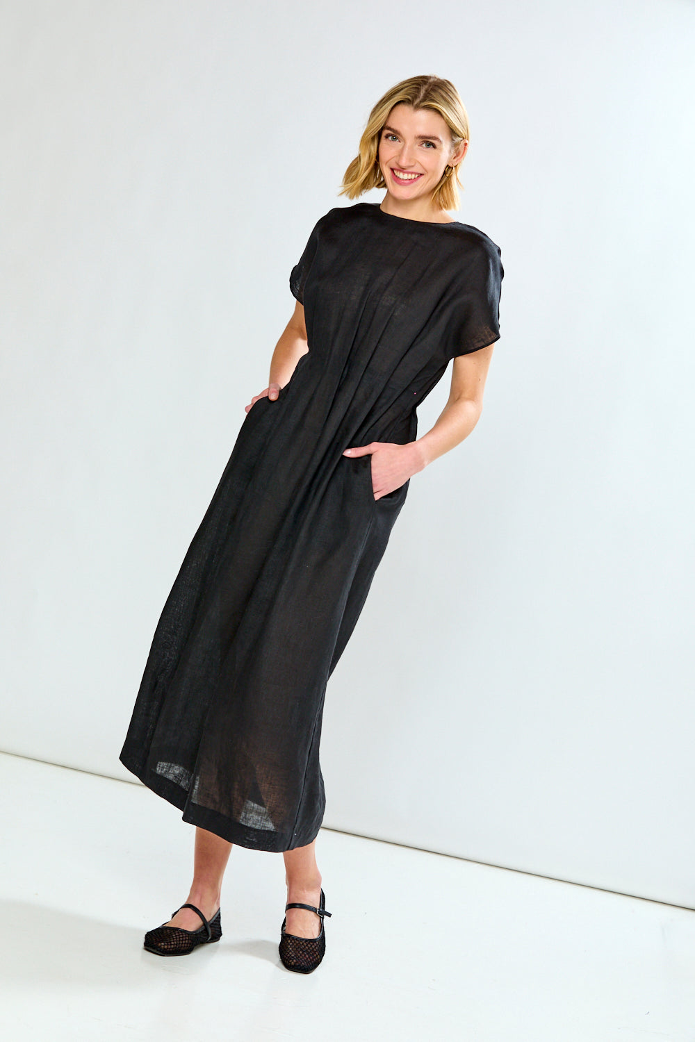 Woman wearing a black dress against a white background