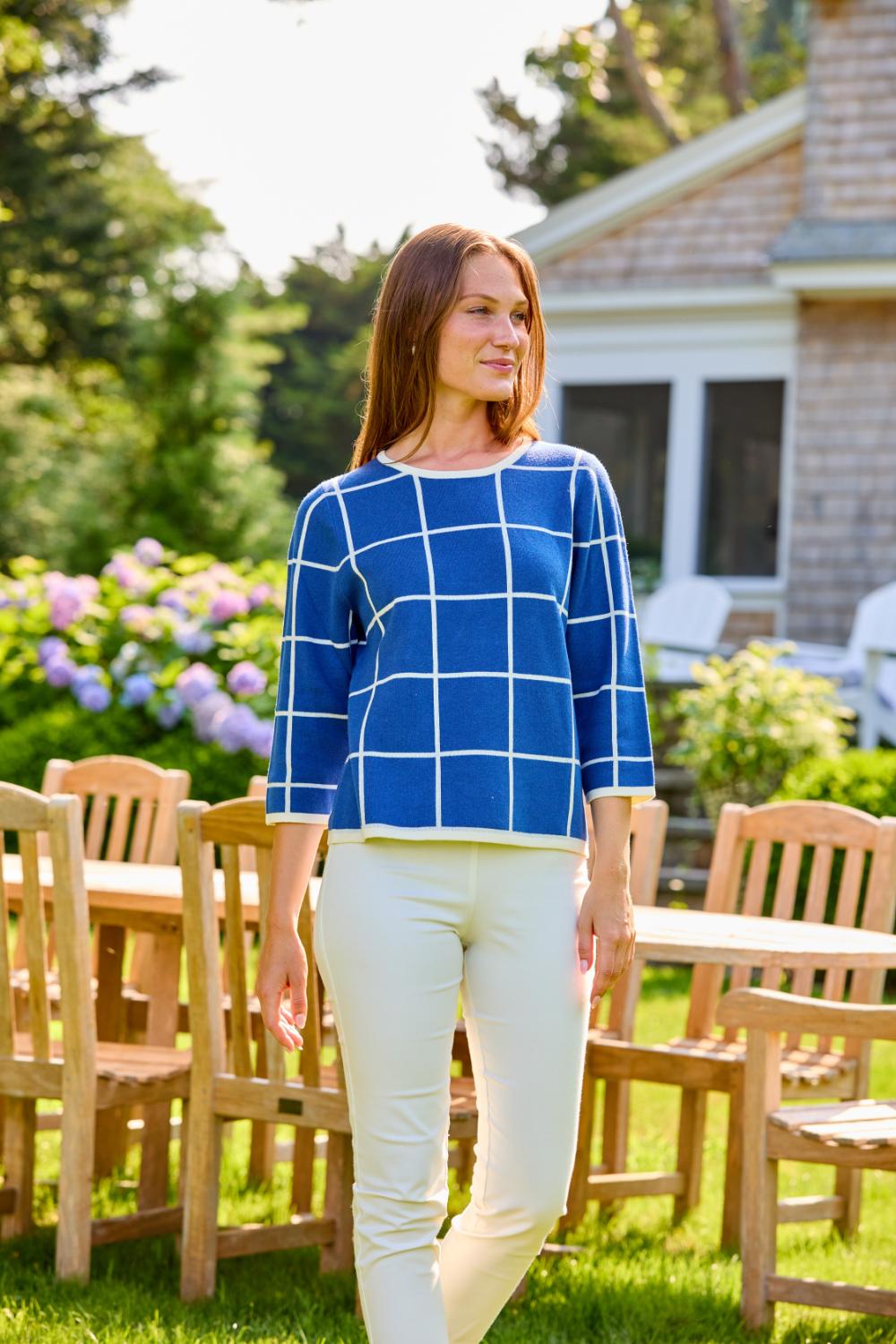 Woman in blue/ivory windowpane sweater