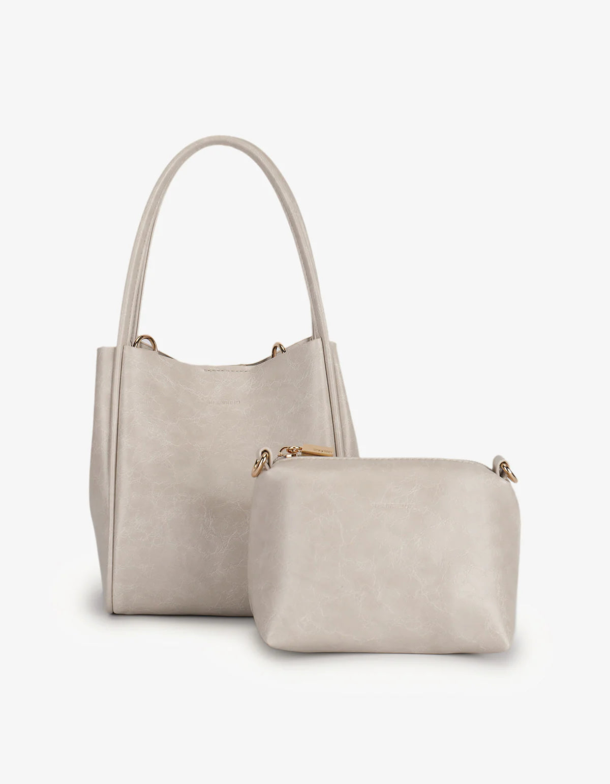Set of two beige handbags on a white background