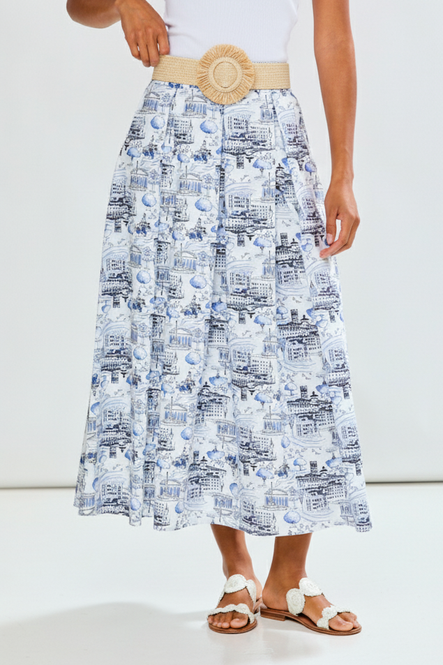 Person wearing a patterned skirt with a belt on a white background