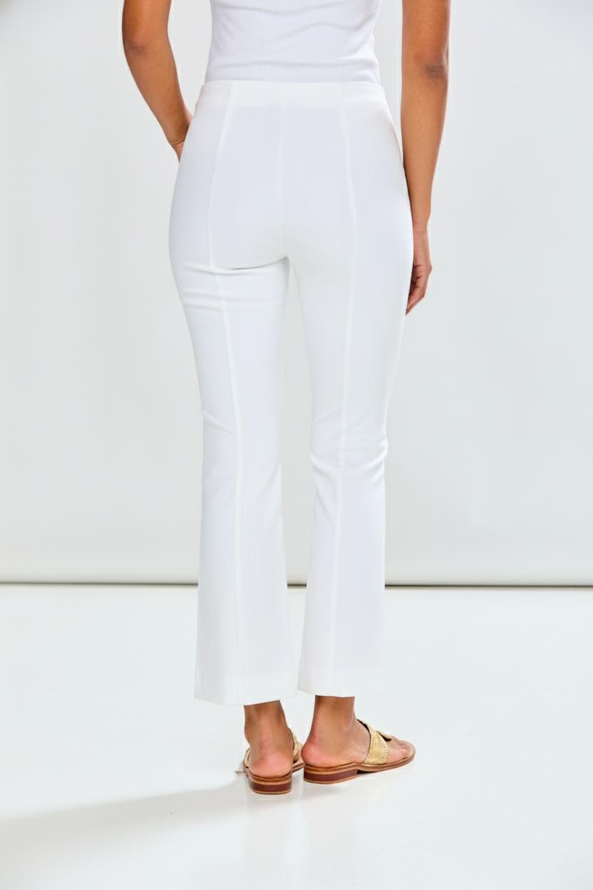 Person wearing a white outfit with a plain background