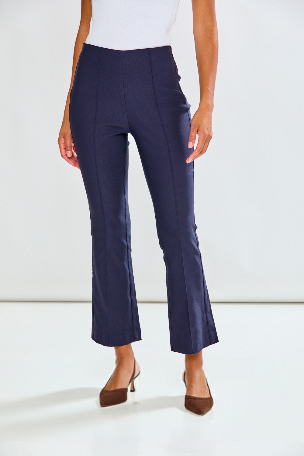 Navy blue pants worn by a person on a white background