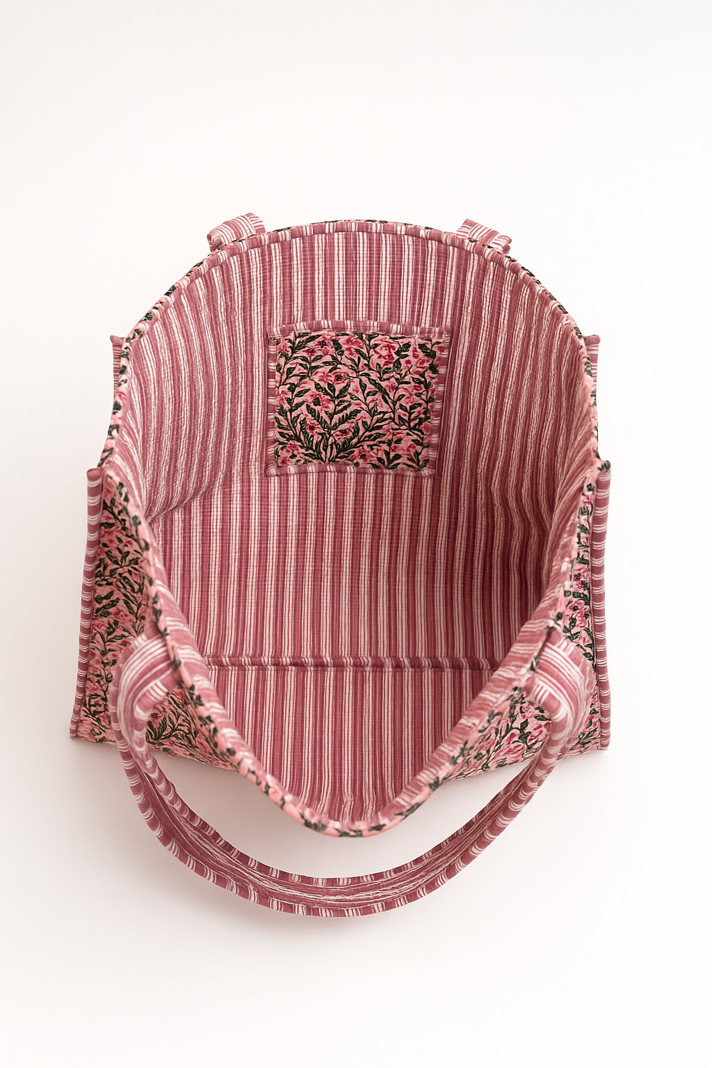 Red and white striped baby carrier with floral embroidery on a white background