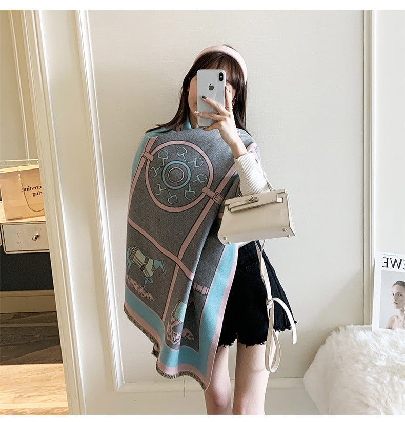 Person wearing a patterned scarf and holding a handbag in a room.