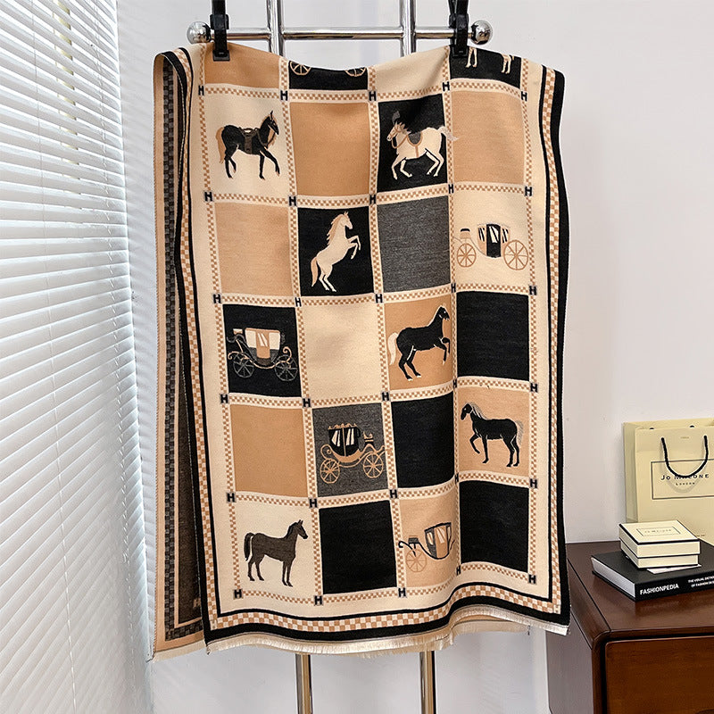 Quilt with horse and carriage patterns hanging on a rack.