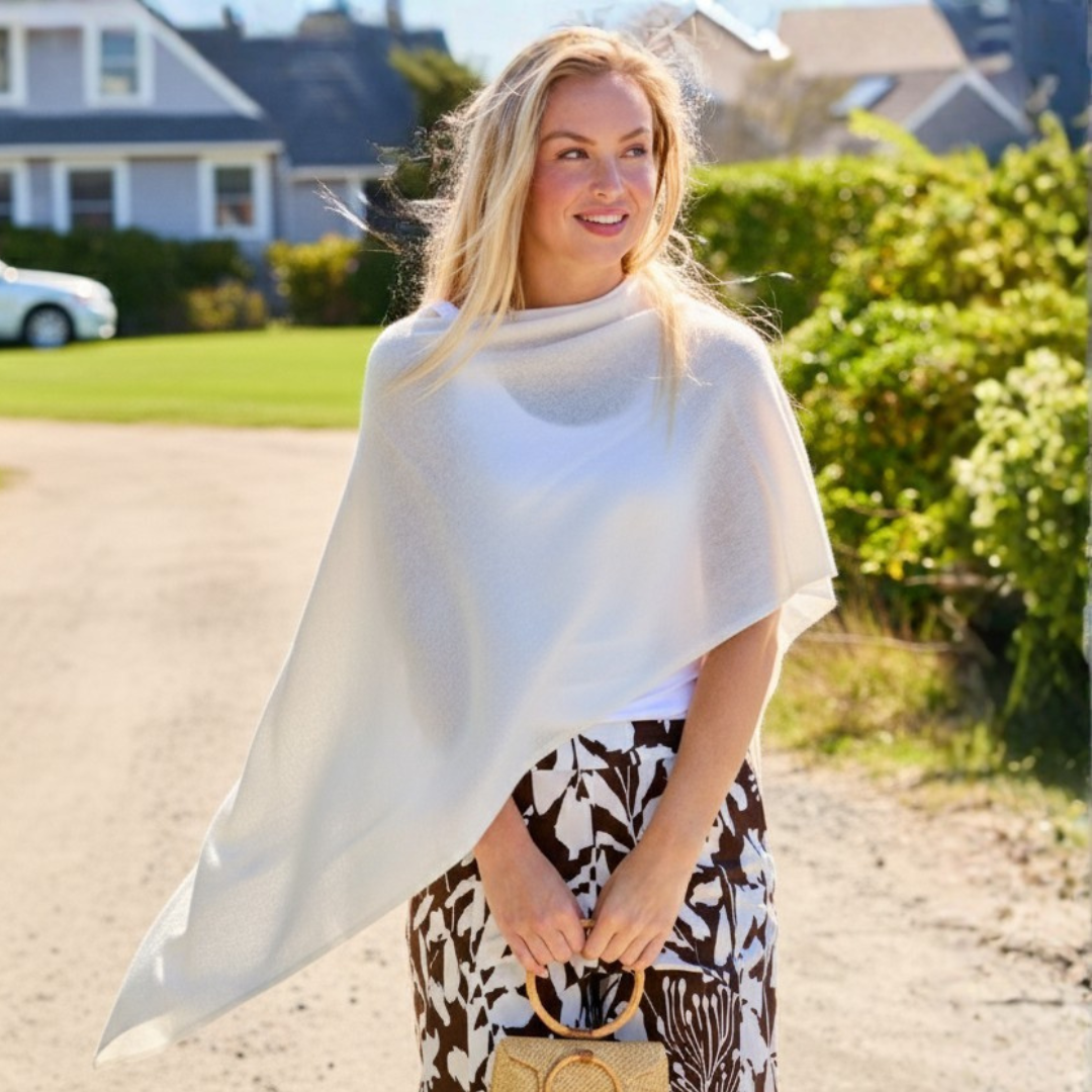 Girl wearing a ruana and holding a purse