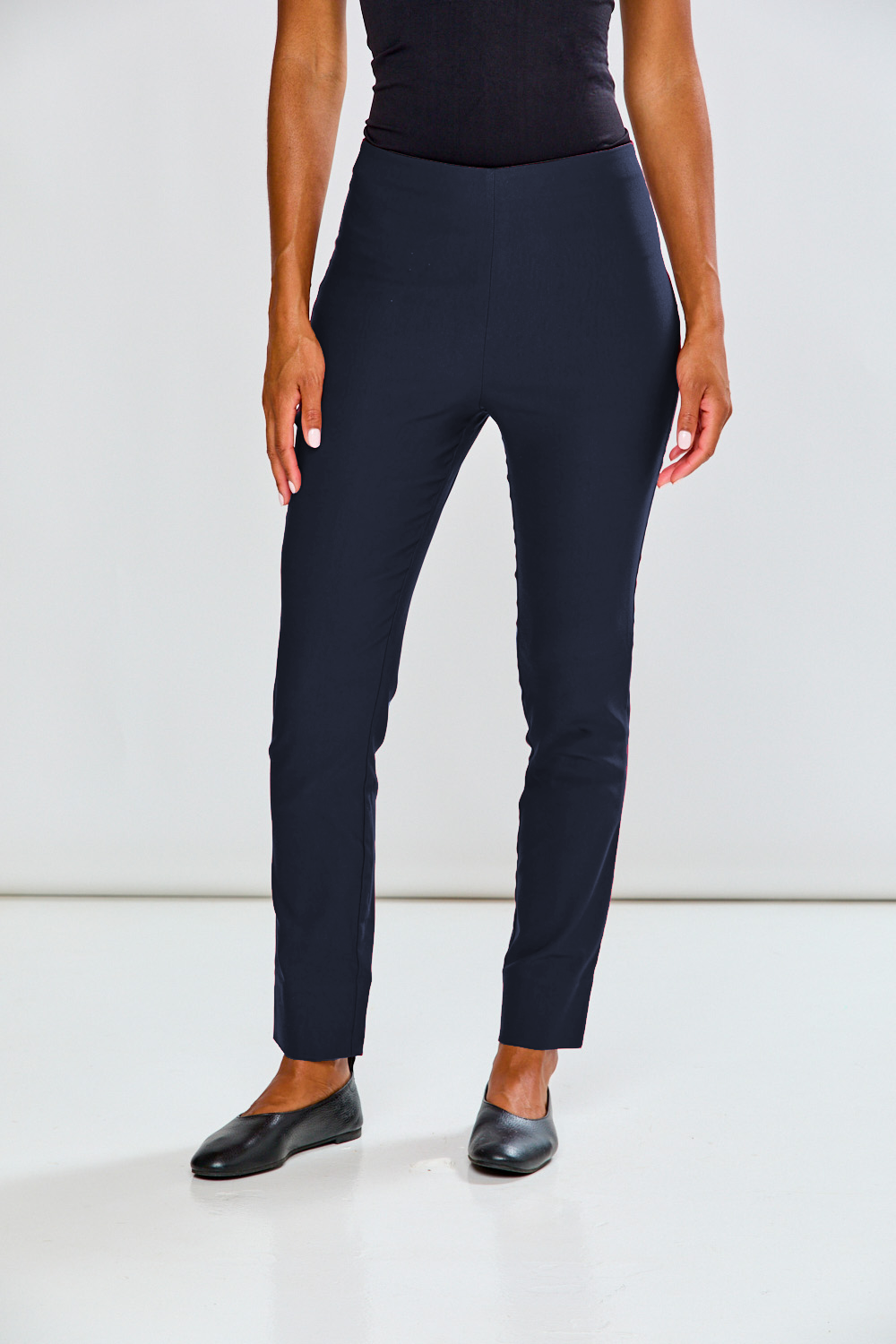 Person wearing navy blue pants on a white background