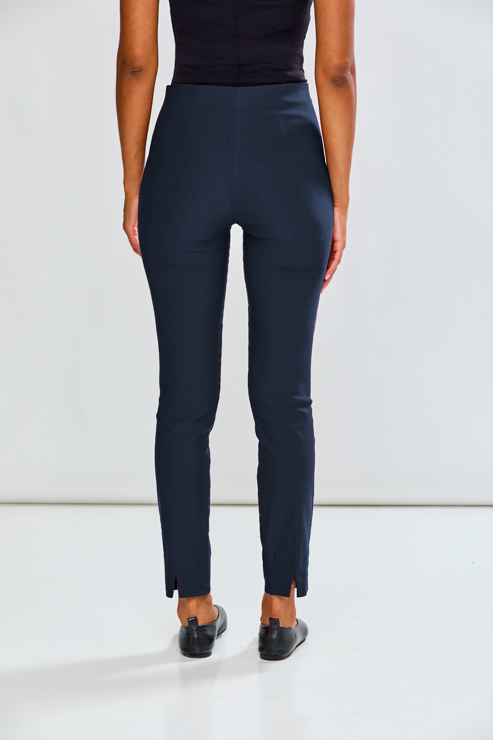 Person wearing navy blue pants on a white background