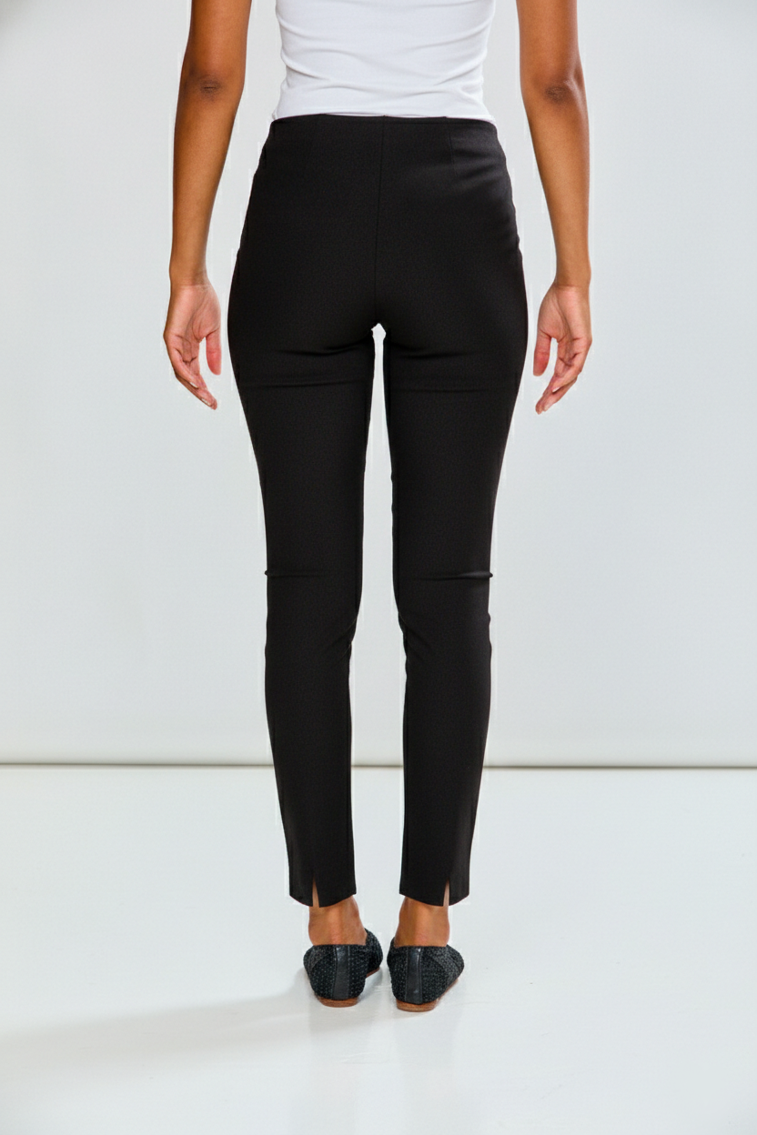 Person wearing black pants on a white background