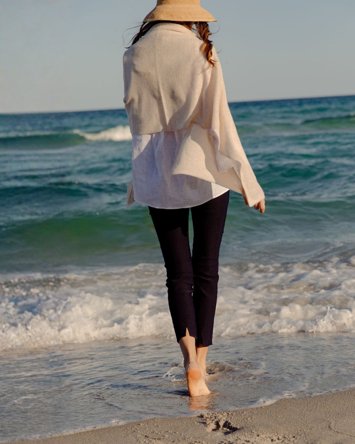 Girl walking on beach in sheri pants