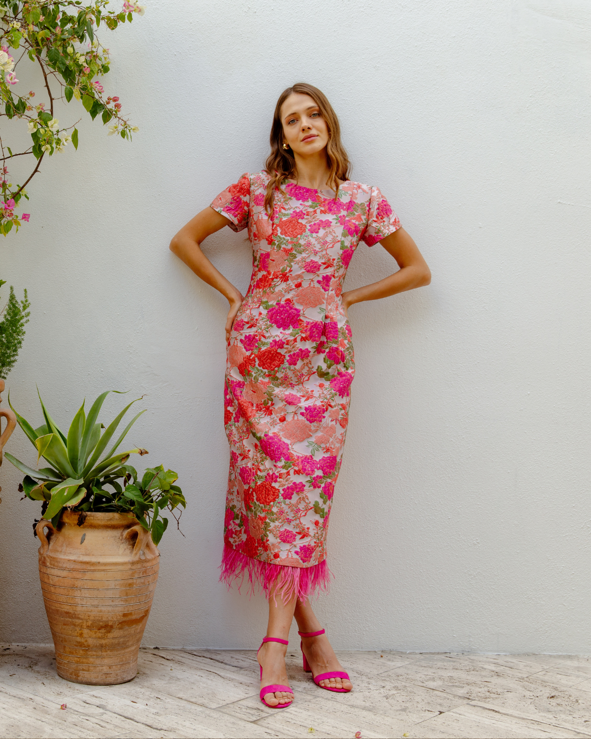 Girl leaning on wall in event dress